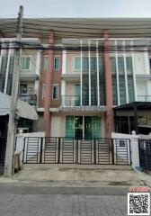 Modern two-story residential townhouse with gated entrance