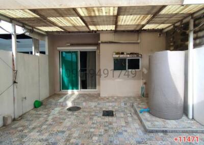 Spacious outdoor patio with patterned tile flooring and partial roofing