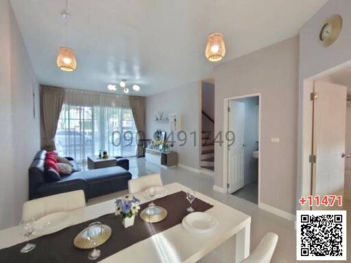 Spacious and well-lit living room with modern furnishings and balcony access