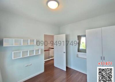 Spacious bedroom with ample natural light and built-in storage