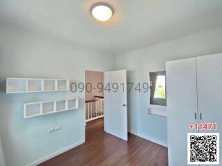 Spacious bedroom with ample natural light and built-in storage