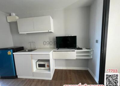 Compact studio apartment kitchen with integrated living space
