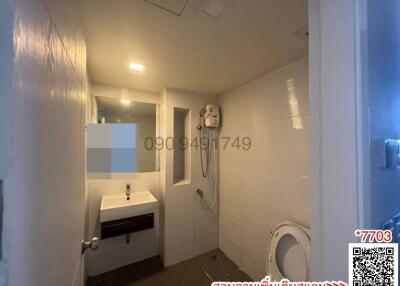 Spacious bathroom with white tiles and modern fittings