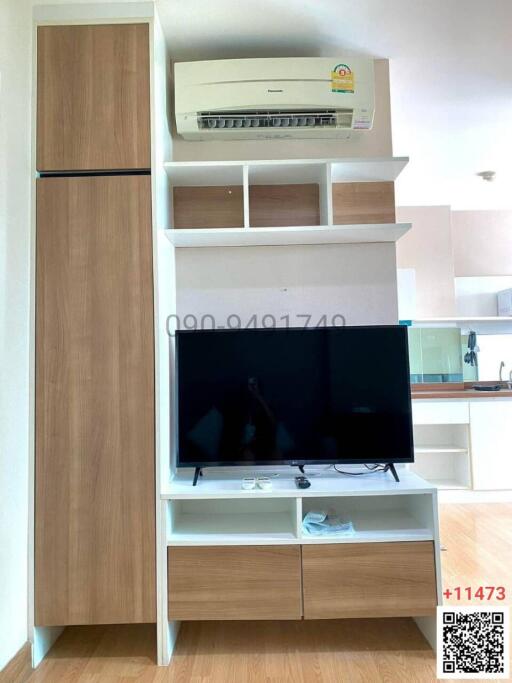 Modern living room with built-in media cabinet and air conditioning unit