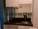 Compact modern kitchen with fitted cabinets and sink