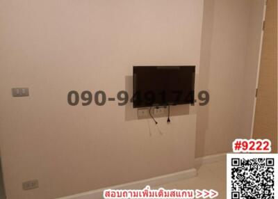 Empty bedroom with wall-mounted TV