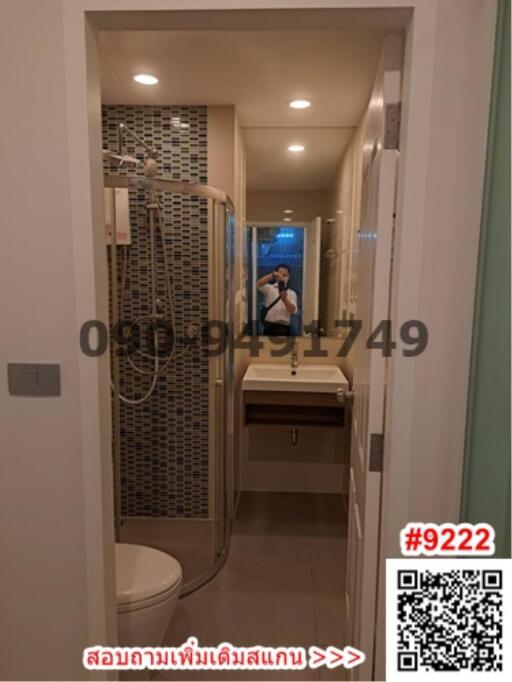 Modern bathroom interior with shower cubicle, toilet, and sink