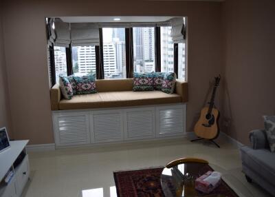 Cozy living room with a window seat overlooking the city