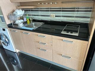 Modern kitchen with built-in appliances and wooden cabinetry