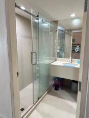 Modern bathroom with glass shower enclosure and well-lit vanity area