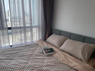 Modern bedroom with large window and city view