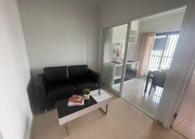 Modern living room with black sofa and minimalist decor