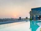 Luxurious rooftop pool overlooking city skyline at sunset