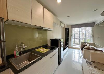 Modern kitchen with adjacent living area in a bright apartment