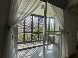 Bright and spacious balcony with privacy screen and sliding doors