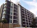 Exterior view of a modern multi-story residential building with balconies