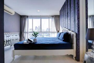 Elegant bedroom with modern design and city view