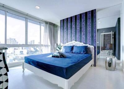 Modern bedroom with large window and city view