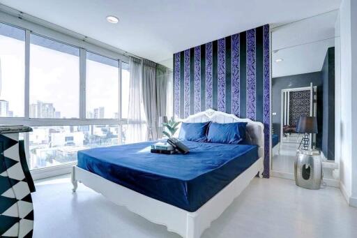 Modern bedroom with large window and city view