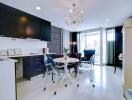 Elegant modern kitchen with dining area, featuring black cabinetry and a chic glass dining table