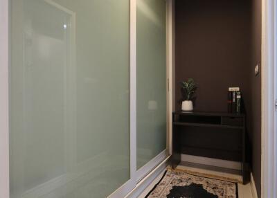 Modern entryway with glass door and decorative plant