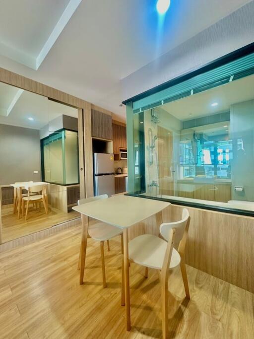 Modern kitchen with glass partition and wooden accents
