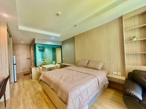 Spacious bedroom with modern furniture and balcony access
