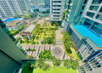 Aerial view of modern residential complex with lush garden and pool