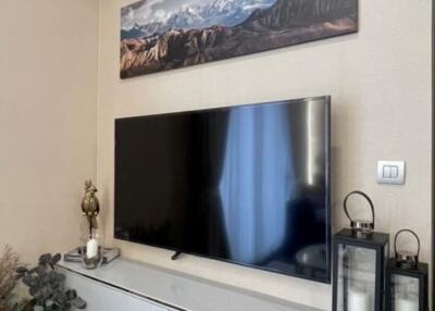 Modern living room with wall-mounted television and decorative items