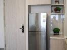 Modern kitchen with built-in cabinetry and stainless steel refrigerator