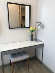 Modern bedroom corner with simple stylish desk and decorative mirror