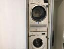 Stacked washing machine and dryer in a modern laundry room