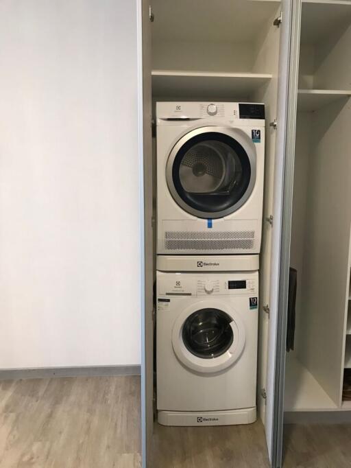 Stacked washing machine and dryer in a modern laundry room