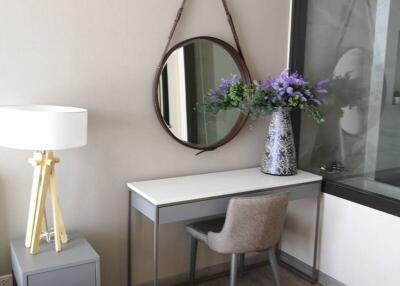 Cozy bedroom corner with stylish desk and decorative mirror