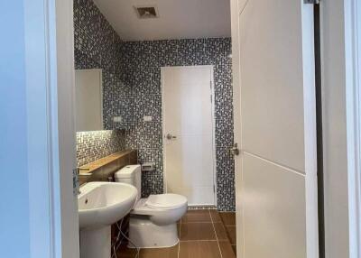 Modern bathroom interior with patterned tiles and white fixtures