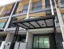 Modern townhouse exterior with secure entrance and ample parking