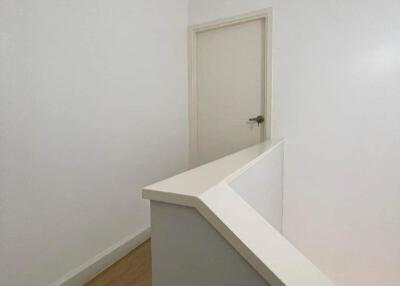 Clean and minimalist hallway leading to a door
