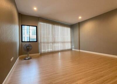 Spacious and well-lit living room with hardwood floors and large windows