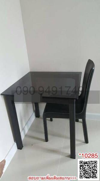 Compact black dining table with one chair in a kitchen area