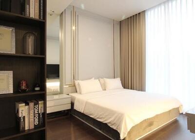 Modern bedroom with large bed and stylish shelving