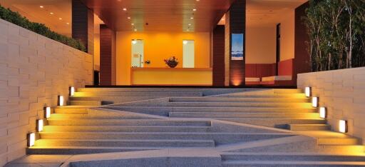 Elegant modern home entrance at twilight with illuminated pathway