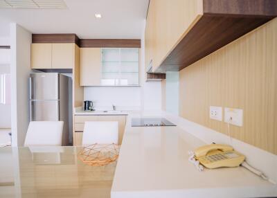 Modern kitchen with white countertops and wooden cabinetry