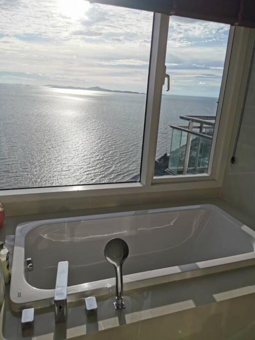 Luxurious bathroom with ocean view through large window