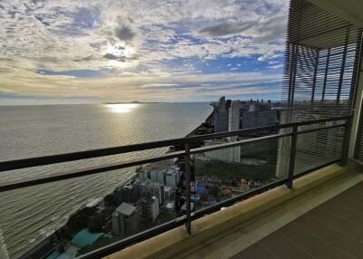 Spacious balcony overlooking the ocean and cityscape at sunset