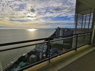 Spacious balcony overlooking the ocean and cityscape at sunset
