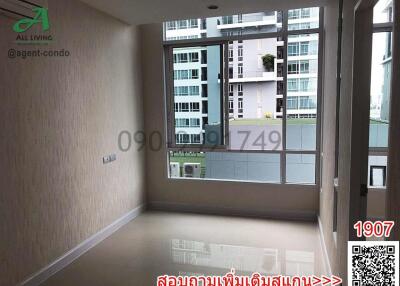 Spacious bedroom with large windows and city view