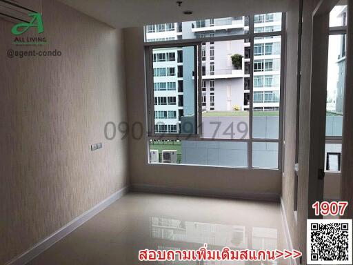 Spacious bedroom with large windows and city view