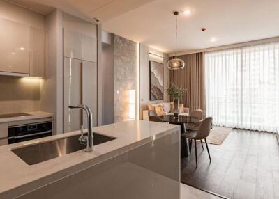 Modern kitchen with integrated dining space featuring sleek design and natural light