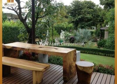 Tranquil garden with wooden bench and lush greenery