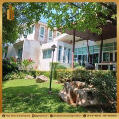 Modern residential building with spacious green lawn and garden